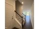 Inviting entryway with a staircase, leading to an open-concept living area with lots of natural light and dark hardwood flooring at 26 Twin Birch Dr, Angier, NC 27501