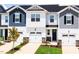 New townhomes feature attached garages, black shutters, manicured lawns, and Craftsman-style details at 26 Twin Birch Dr, Angier, NC 27501
