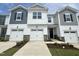 Beautiful townhome exterior showcases a two-car garage, lovely landscaping and grey and white color scheme at 26 Twin Birch Dr, Angier, NC 27501