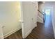 Open-concept hallway next to powder room with wood floors and stairway to the second level at 26 Twin Birch Dr, Angier, NC 27501