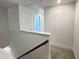 Upstairs hallway with neutral carpet and white walls leads to various rooms at 26 Twin Birch Dr, Angier, NC 27501