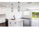 Open-concept kitchen featuring an island with a sink, stainless appliances, and pendant lights at 26 Twin Birch Dr, Angier, NC 27501