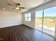 Living room with wood floors, ceiling fan, and sliding glass doors overlooking the backyard at 26 Twin Birch Dr, Angier, NC 27501