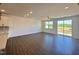 Bright living room with hardwood floors, a ceiling fan, and sliding glass doors leading to the backyard at 26 Twin Birch Dr, Angier, NC 27501