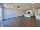 Open concept living space featuring a kitchen with white cabinets and a kitchen island and a living room area with hardwood floors at 26 Twin Birch Dr, Angier, NC 27501