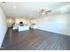 Open concept living space featuring a kitchen with white cabinets and a kitchen island and a living room area with hardwood floors at 26 Twin Birch Dr, Angier, NC 27501