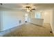 Spacious loft area with plush carpet, ceiling fan, and natural light at 26 Twin Birch Dr, Angier, NC 27501