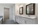 Bathroom featuring dual vanity, modern fixtures, and an open doorway at 261 Umstead St, Sanford, NC 27330
