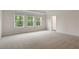 This is a spacious bedroom with carpet, three windows and ample natural light at 261 Umstead St, Sanford, NC 27330