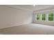 This is a spacious bedroom with carpet, three windows and ample natural light at 261 Umstead St, Sanford, NC 27330