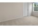 This bedroom features neutral walls, carpet flooring, and a window letting in natural light at 261 Umstead St, Sanford, NC 27330