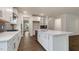 Bright, open kitchen with white cabinets, a spacious island, and modern appliances at 261 Umstead St, Sanford, NC 27330