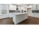 Elegant kitchen featuring a central island, white cabinetry, and stainless steel fixtures at 261 Umstead St, Sanford, NC 27330