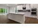 Bright kitchen showcases a center island, white cabinets, and stainless steel appliances at 261 Umstead St, Sanford, NC 27330