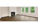 Bright living room featuring a modern fireplace, hardwood floors, and large windows overlooking a lush green landscape at 261 Umstead St, Sanford, NC 27330