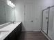 Bright bathroom featuring a double sink vanity with modern fixtures and a glass-enclosed shower at 273 Marvel Dr # 139, Rolesville, NC 27571