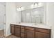 Well-lit bathroom featuring a double sink vanity with wooden cabinets and an expansive mirror at 273 Marvel Dr # 139, Rolesville, NC 27571