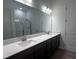 Bright bathroom featuring a double sink vanity with modern fixtures and a glass-enclosed shower at 273 Marvel Dr # 139, Rolesville, NC 27571