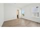Bright bedroom with two windows and a view of the bathroom, and light wood flooring at 273 Marvel Dr # 139, Rolesville, NC 27571