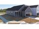 Rear exterior featuring a screened porch, a garage, a sidewalk, and landscaping at 273 Marvel Dr # 139, Rolesville, NC 27571