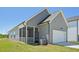The gray vinyl exterior of the home includes a screened porch and a white garage door at 273 Marvel Dr # 139, Rolesville, NC 27571
