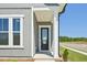Inviting covered front porch with modern columns, a sleek front door, and well-kept landscaping details at 273 Marvel Dr # 139, Rolesville, NC 27571