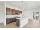 Modern kitchen with dark cabinets, a center island with sink and seating, and stainless steel appliances and fixtures at 273 Marvel Dr # 139, Rolesville, NC 27571