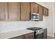 Well-lit kitchen showcasing stainless steel appliances, wood cabinetry, and white marbled backsplash and countertops at 273 Marvel Dr # 139, Rolesville, NC 27571