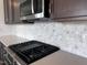 A kitchen featuring quartz countertops, a tile backsplash, and stainless steel appliances at 273 Marvel Dr # 139, Rolesville, NC 27571