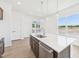Open-concept kitchen island with stainless steel dishwasher, sink, white countertop, and modern pendant lighting at 273 Marvel Dr # 139, Rolesville, NC 27571