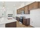 Bright kitchen with stainless steel appliances, marbled backsplash, wooden cabinets, an island, and modern lighting at 273 Marvel Dr # 139, Rolesville, NC 27571