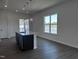 Kitchen featuring dark cabinets, large island and stainless sink with bright natural light at 273 Marvel Dr # 139, Rolesville, NC 27571