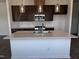 A kitchen featuring an island with quartz countertops, stainless appliances, and dark cabinets at 273 Marvel Dr # 139, Rolesville, NC 27571