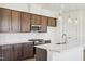 Bright kitchen featuring wooden cabinets, stainless steel appliances, an island, and modern pendant lighting at 273 Marvel Dr # 139, Rolesville, NC 27571