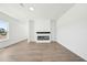 Modern living room featuring stylish wood flooring, a sleek fireplace, and neutral walls with lots of natural light at 273 Marvel Dr # 139, Rolesville, NC 27571