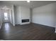 Bright living room with luxury vinyl flooring and a modern, recessed electric fireplace at 273 Marvel Dr # 139, Rolesville, NC 27571