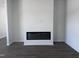 Bright living room with luxury vinyl flooring and a modern, recessed electric fireplace at 273 Marvel Dr # 139, Rolesville, NC 27571
