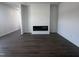 Bright living room with luxury vinyl flooring and a modern, recessed electric fireplace at 273 Marvel Dr # 139, Rolesville, NC 27571