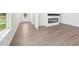 Open-concept living area features elegant wood flooring, modern fireplace, and large windows for natural light at 273 Marvel Dr # 139, Rolesville, NC 27571