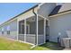 A close up view of the home's screened porch, gray vinyl siding and Lennox outdoor AC unit at 273 Marvel Dr # 139, Rolesville, NC 27571