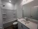 This bathroom features a shower and tub combo, a single sink vanity, and wood-look floors at 2880 Quarry Rd # 163, Rolesville, NC 27571