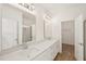 Bright bathroom featuring double sinks with quartz counters and modern lighting at 2880 Quarry Rd # 163, Rolesville, NC 27571