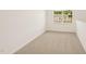 The room has a light carpet, white walls, and a window at 2880 Quarry Rd # 163, Rolesville, NC 27571