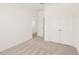 Carpeted bedroom features neutral decor, an open doorway, and double-door closet at 2880 Quarry Rd # 163, Rolesville, NC 27571