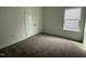 This bedroom features a window with blinds, neutral carpet, and a double-door closet at 2880 Quarry Rd # 163, Rolesville, NC 27571