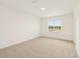 The bedroom has light carpet, white walls, and a window with a view at 2880 Quarry Rd # 163, Rolesville, NC 27571