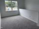 Upstairs bonus room featuring neutral carpet, a large window, and ample natural light at 2880 Quarry Rd # 163, Rolesville, NC 27571