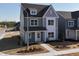 Charming two-story home with a mix of gray siding, white trim and a beautifully landscaped front yard at 2880 Quarry Rd # 163, Rolesville, NC 27571