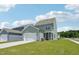 Home exterior features a two-car garage, light green siding and a well-maintained lawn at 2880 Quarry Rd # 163, Rolesville, NC 27571