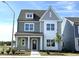 Charming two-story home featuring gray siding, white trim, and a welcoming front porch at 2880 Quarry Rd # 163, Rolesville, NC 27571